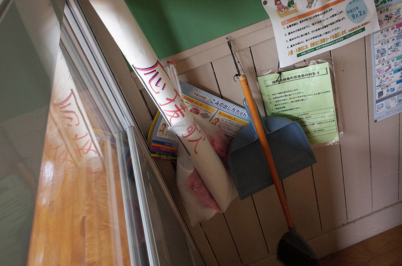 broom and dustpan in the corner of a japanese classroom