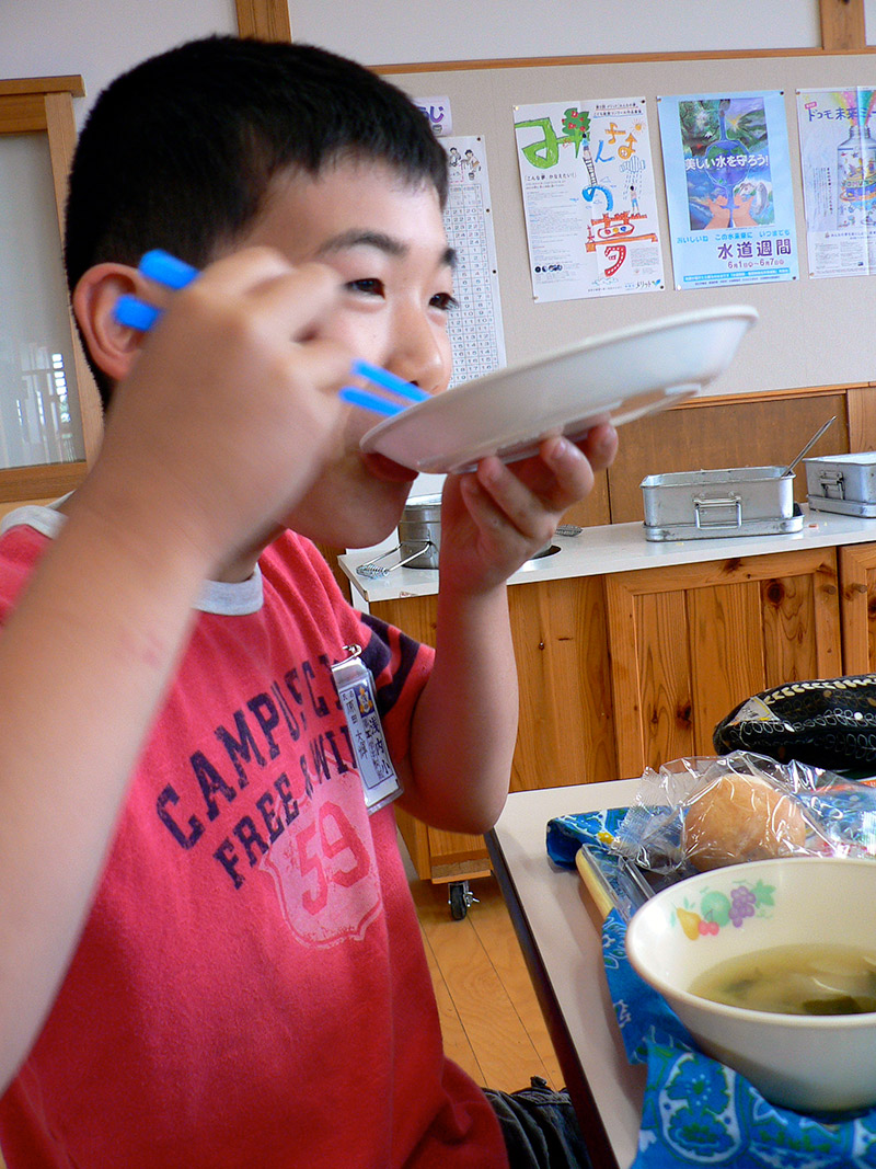 japanese boy eating lunch at school