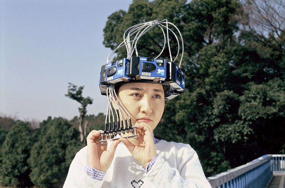 lady with disposable cameras on her head