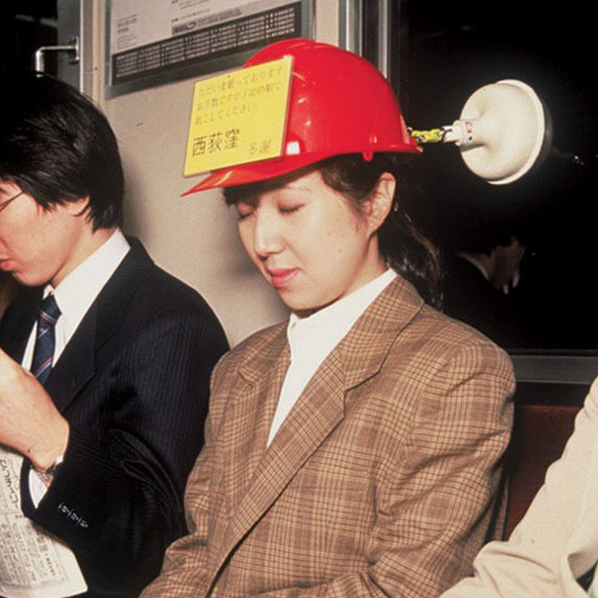 woman wearing hard hat with plunger attached