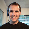 Man with a headset looking into camera