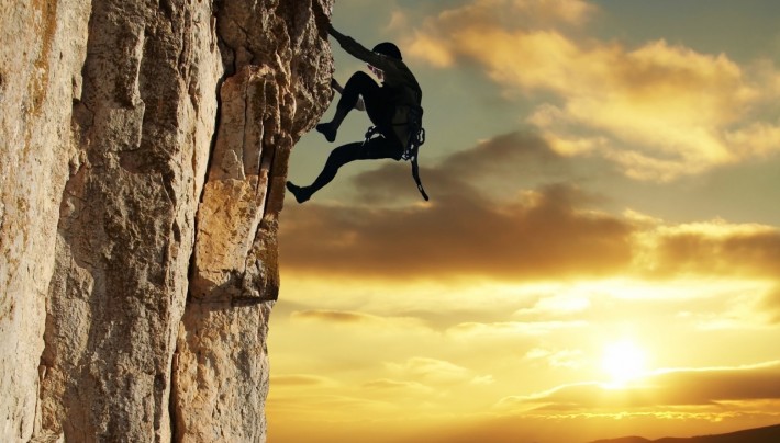 Rock climber silouhetted against the sun