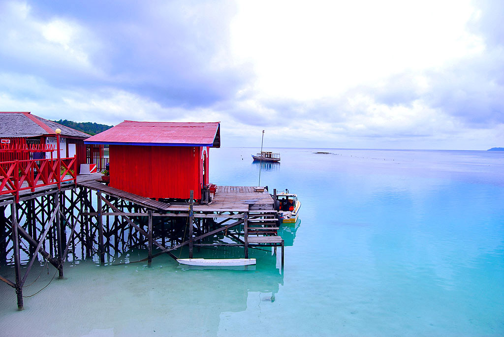 red house on a pier overlooking water