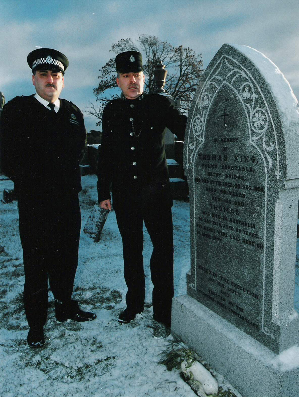 two british policeman by a gravestone