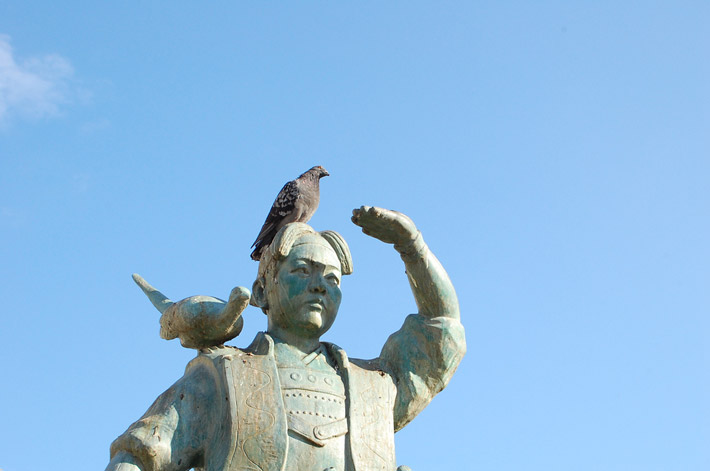 birds perched on statue of child