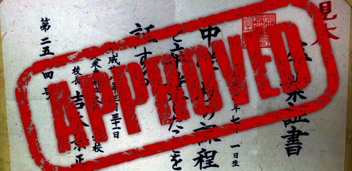 red approved stamp over top kanji