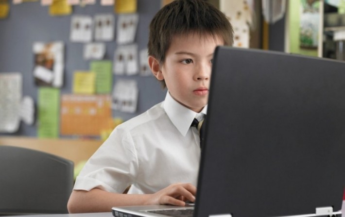 A young boy learning Japanese on his computer