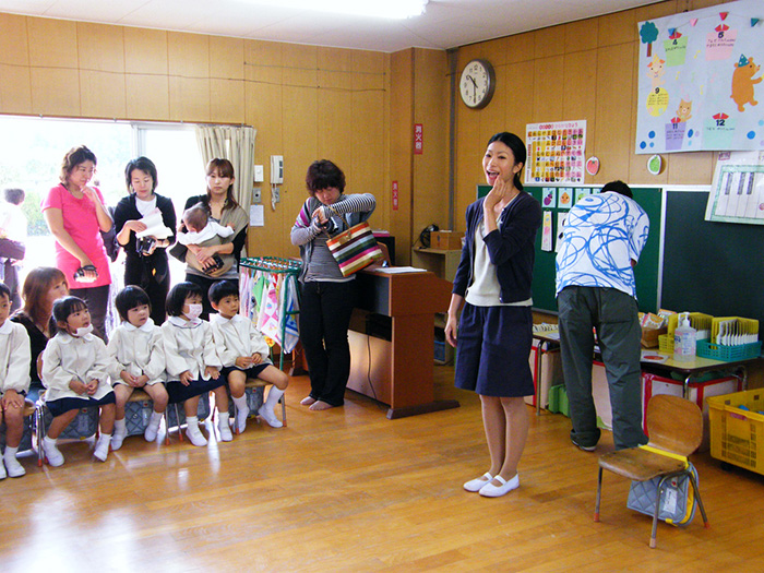 A Japanese teacher addressing her young students