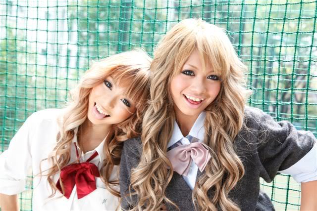 A couple of kogyaru smiling for a photo