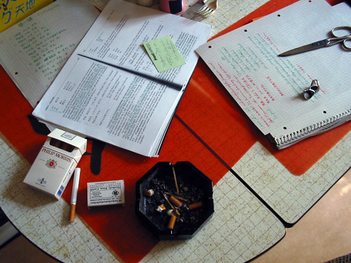 book notepad and ashtray on desk