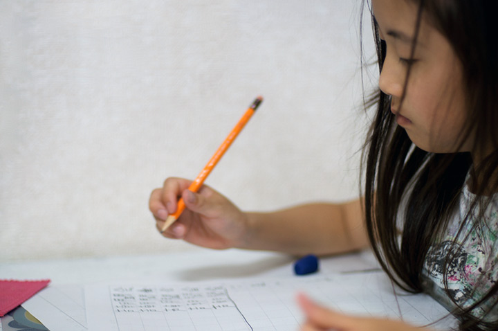 young asian girl studying language textbook