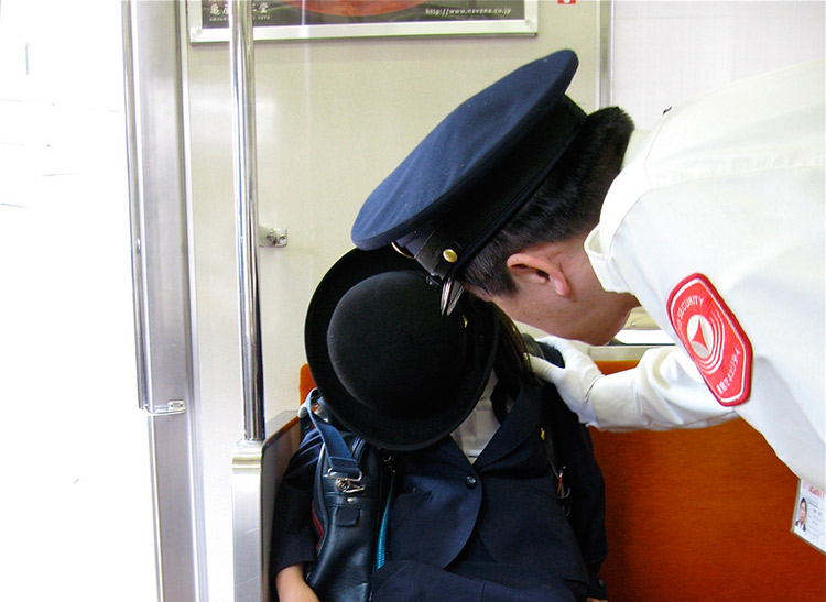 person sleeping on train being woken up