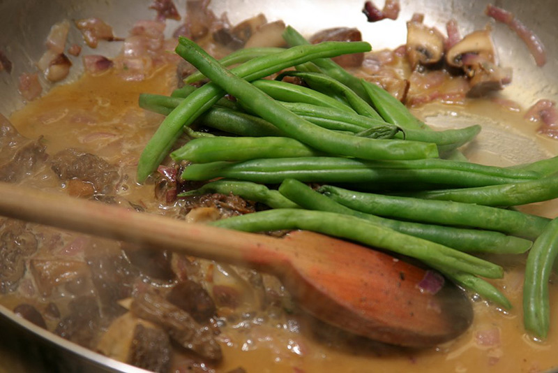 asparagus mushrooms and onions in a fry pan