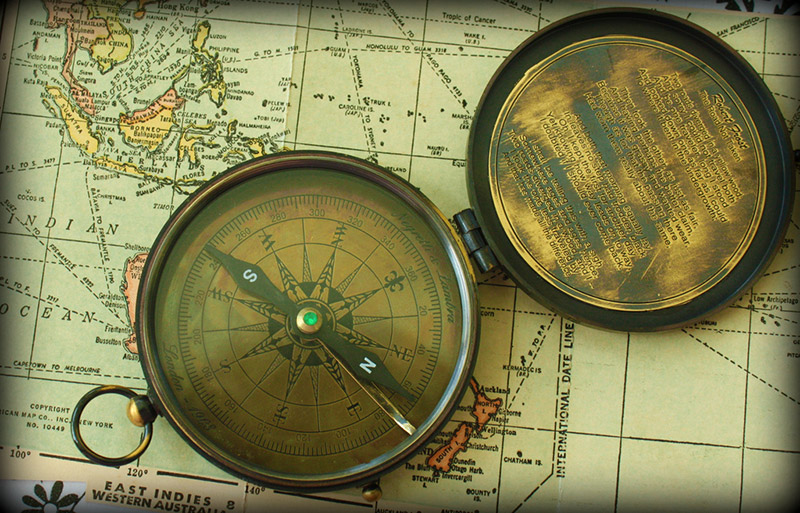 An old compass resting on a map