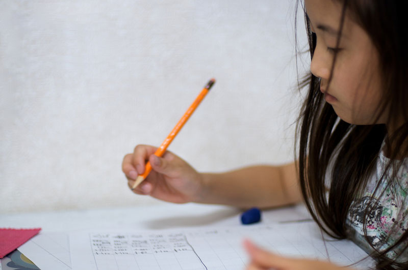 Japanese girl practices kanji