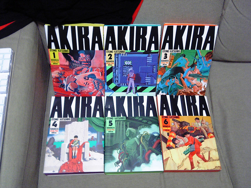 akira book covers arranged on grey couch