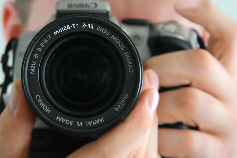 close up of man holding camera