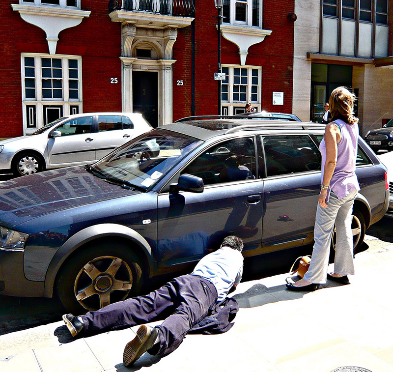 man and woman try and get into locked car