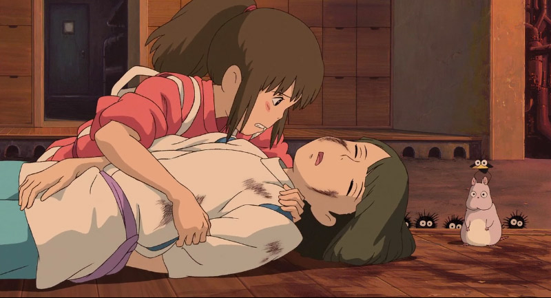 Screenshot of Chihiro holding an unconcious Haku from Spirited Away