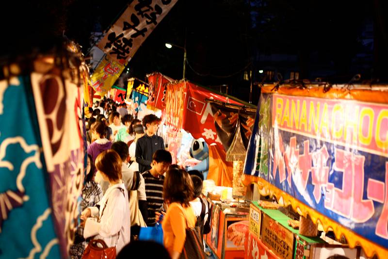 A Row Of Food Booths At A Japanese Festival