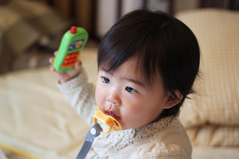 Baby holding a toy phone