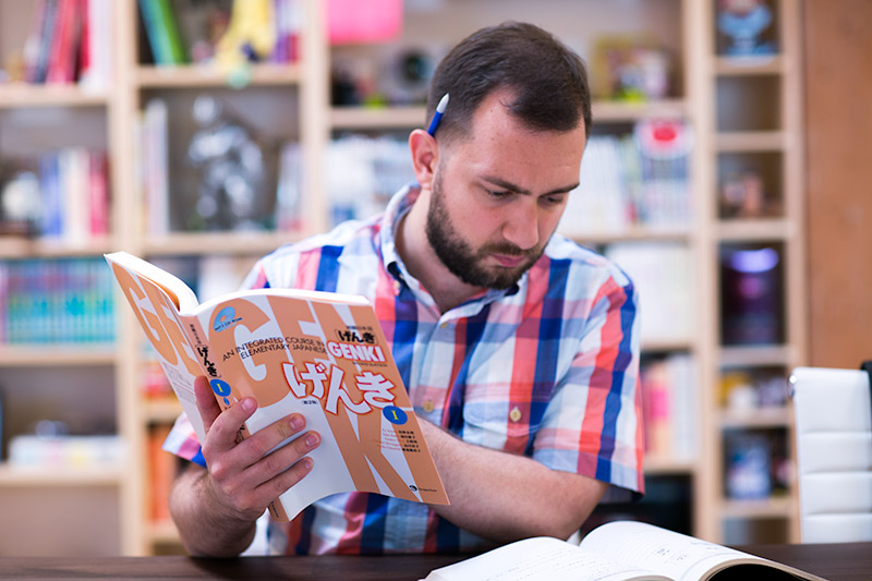 man holding genki book and reading