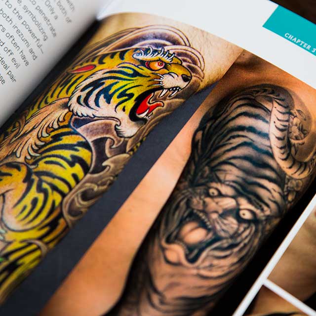 various tiger tattoos in a book