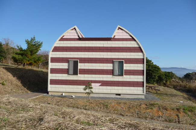 house shaped like cat with red and white siding