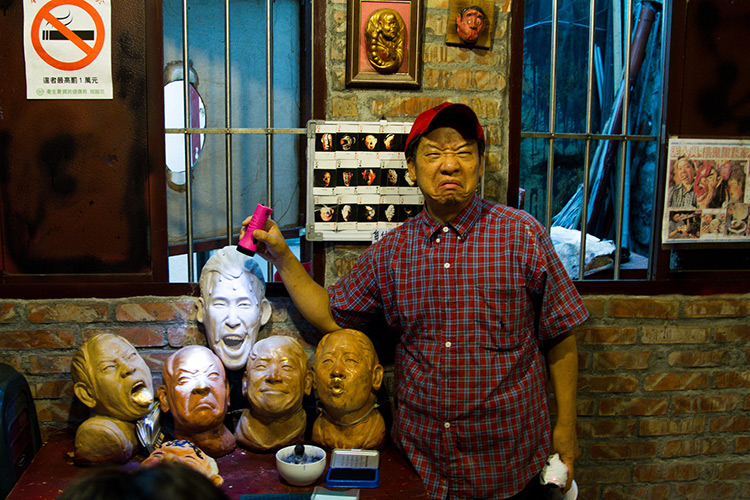 guy making a face next to a pile of heads