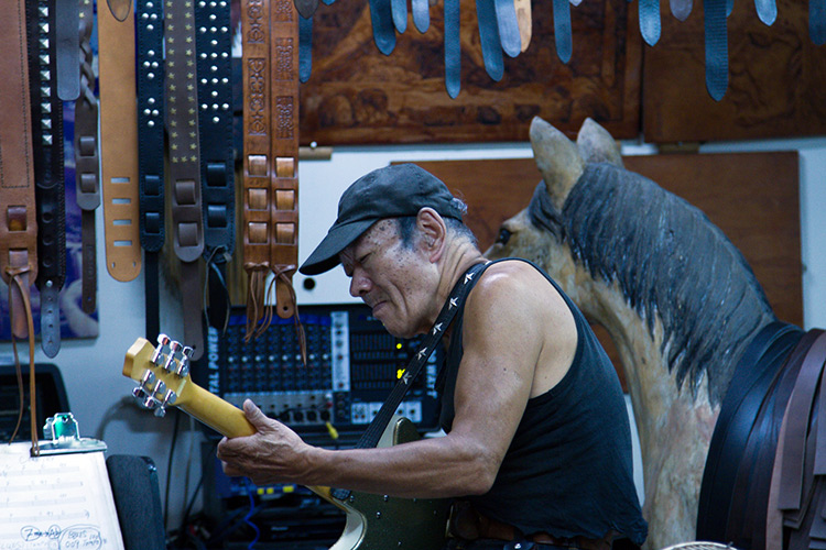 taiwan man playing the guitar kind of a badass plastic horse