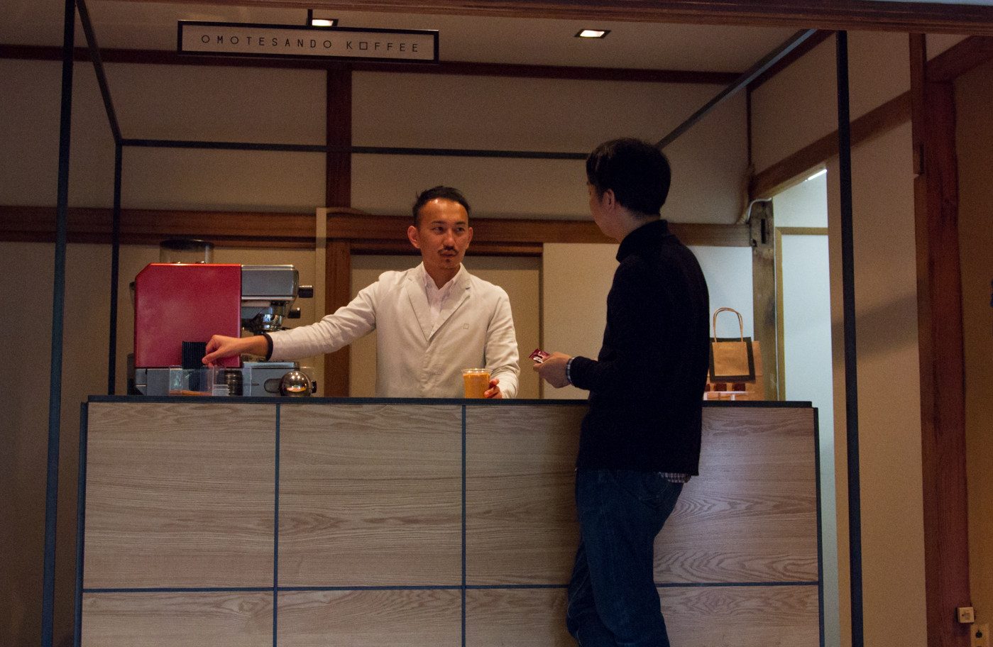 omotesando koffee counter where japanese barista is talking to customer