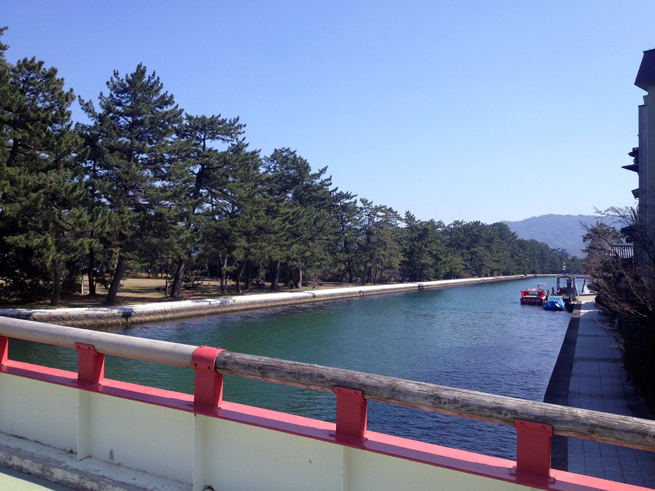 a river and a red bridge japan