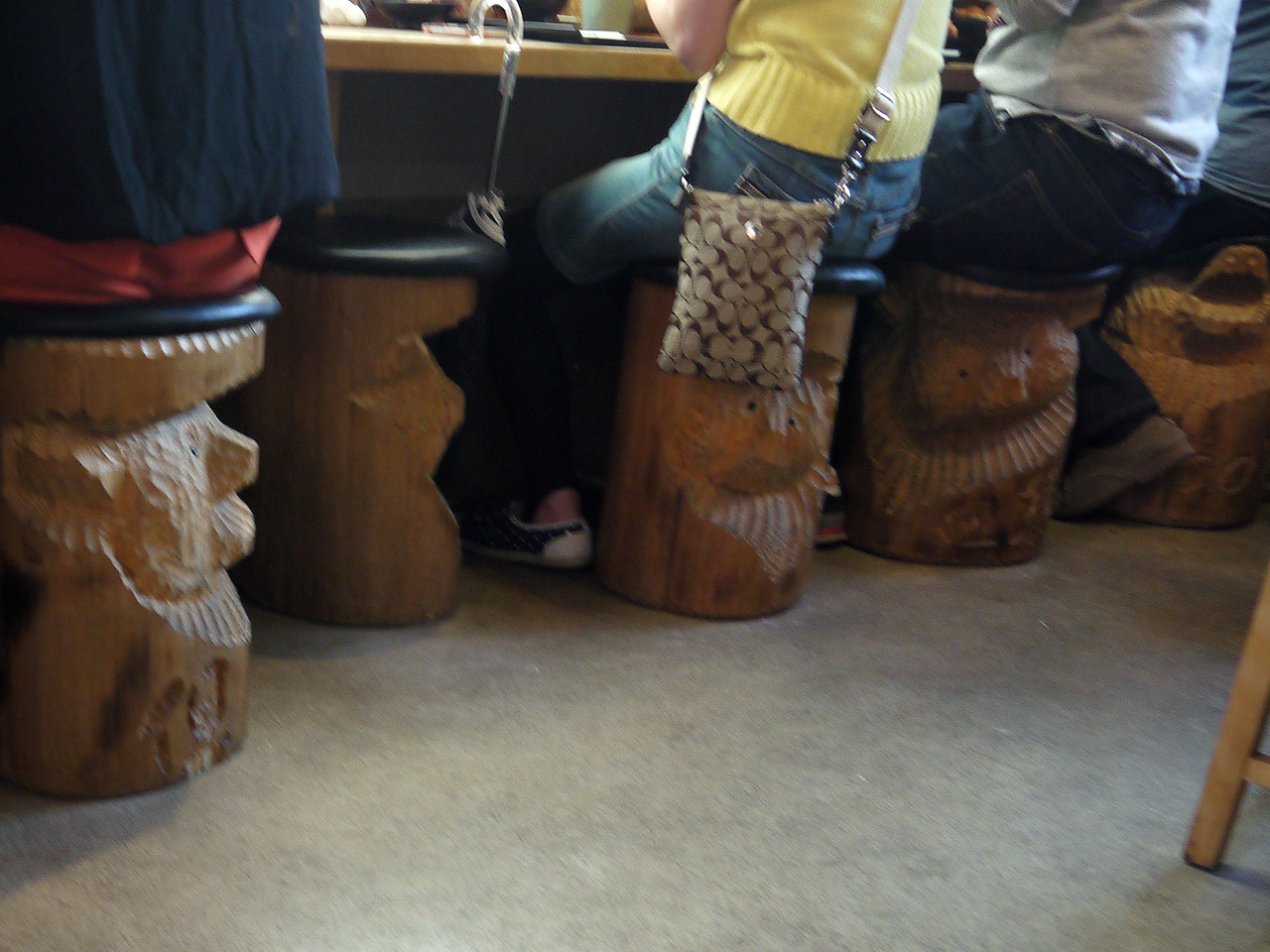 human butts on stools carved to look like bears