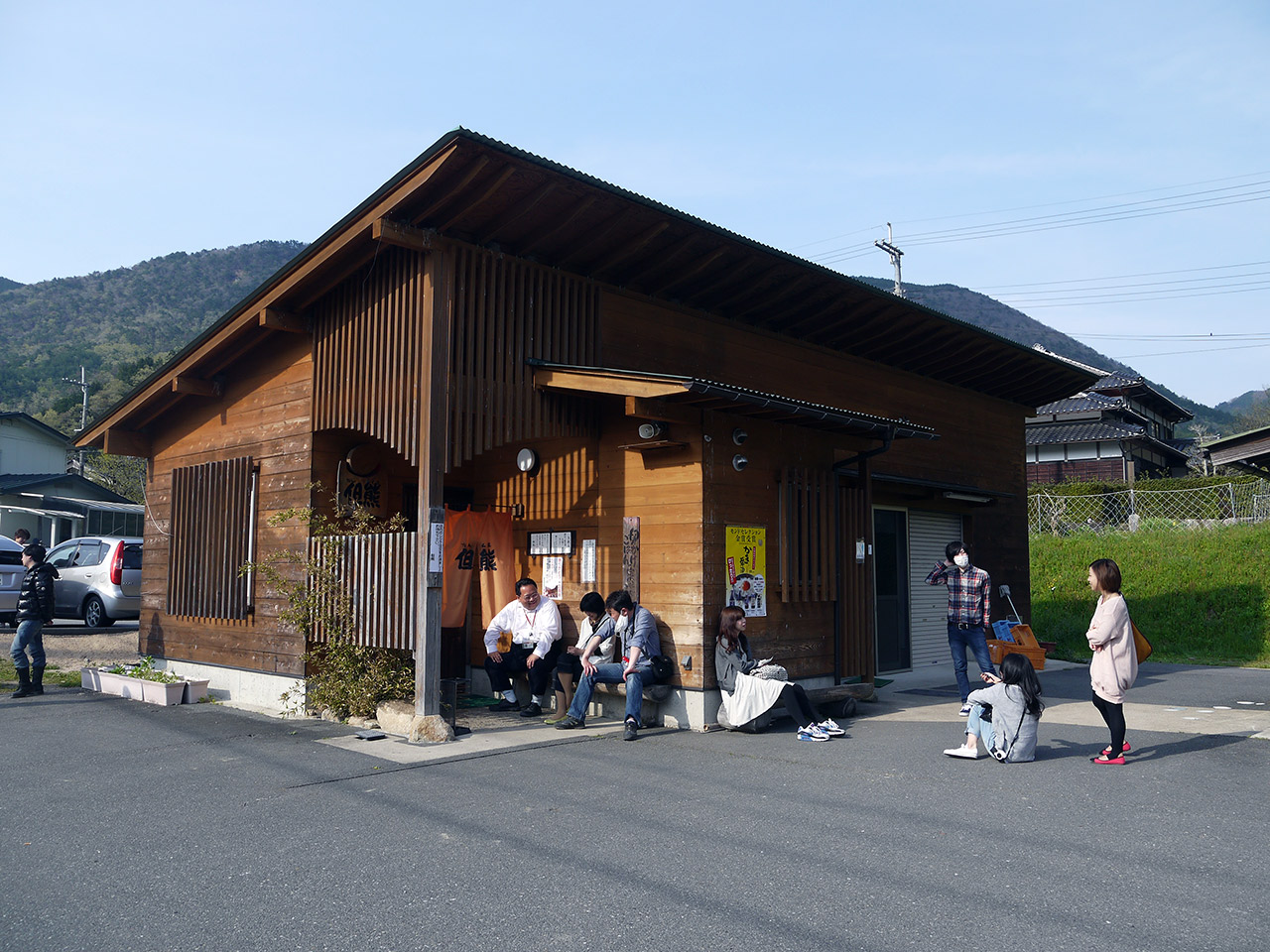 japanese people waiting outside a country restaurant