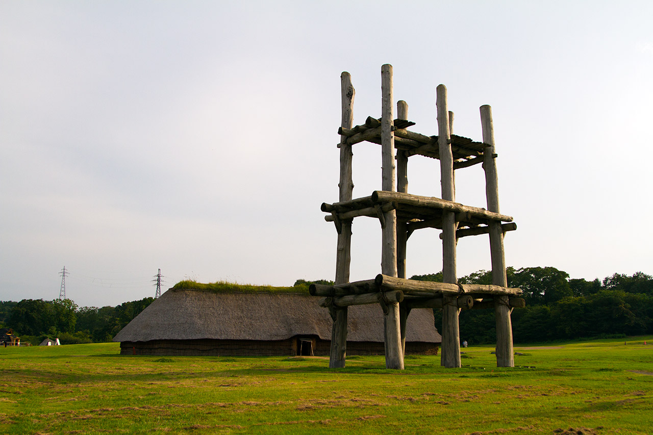 large hut next to pillar structure