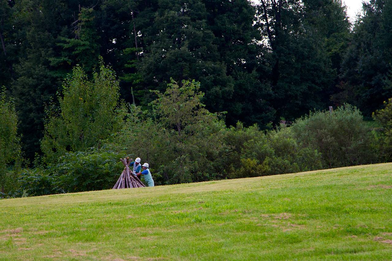 two men building from a distance