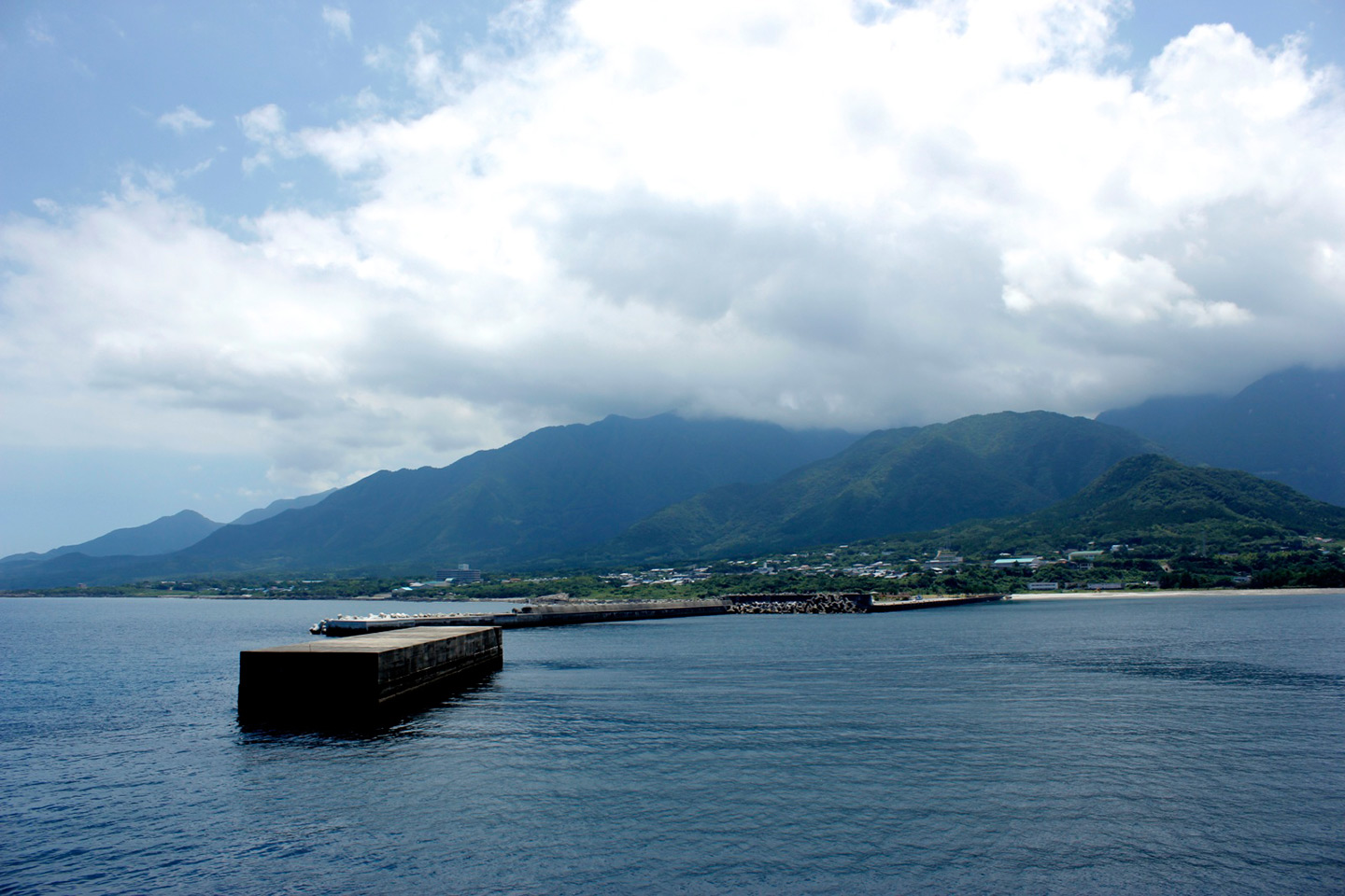 water and mountains in the background