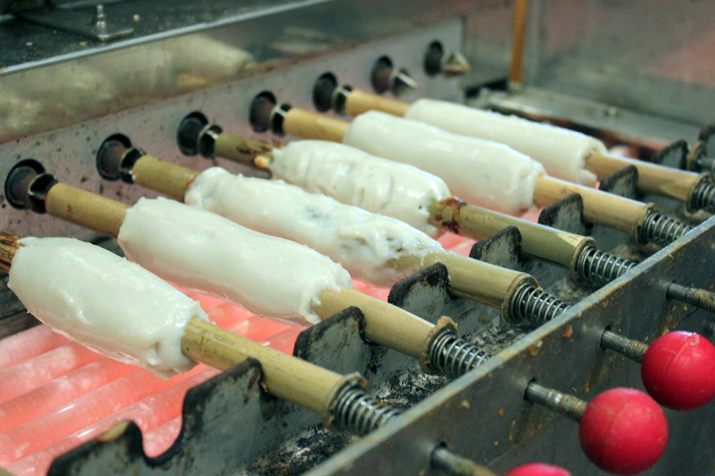 chikuwa being turned and cooked