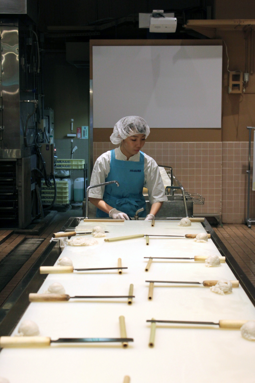Japanese woman at chikuwa making station