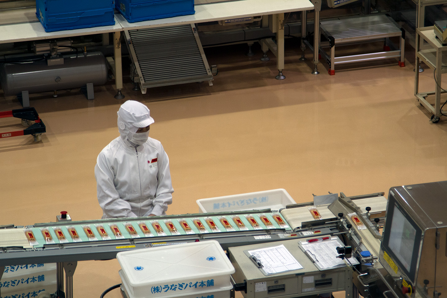 worker on the eel pie factory assembly line