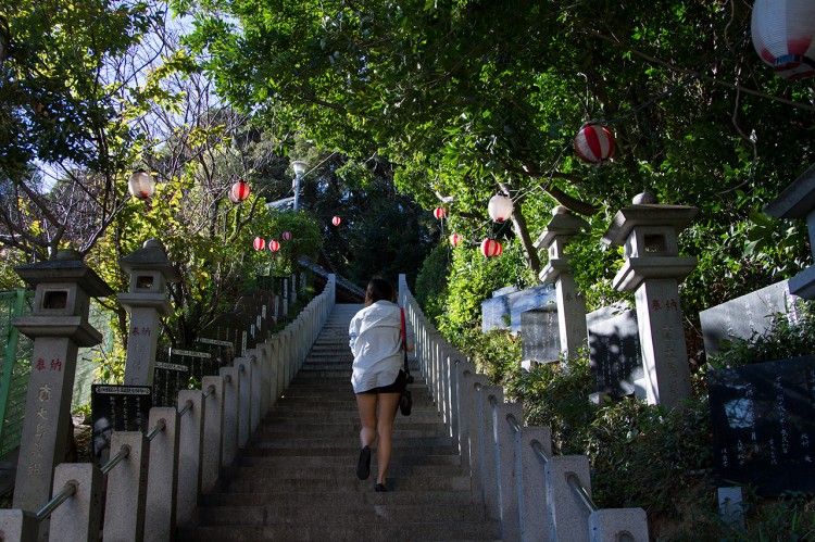 woman goes up temple stairs