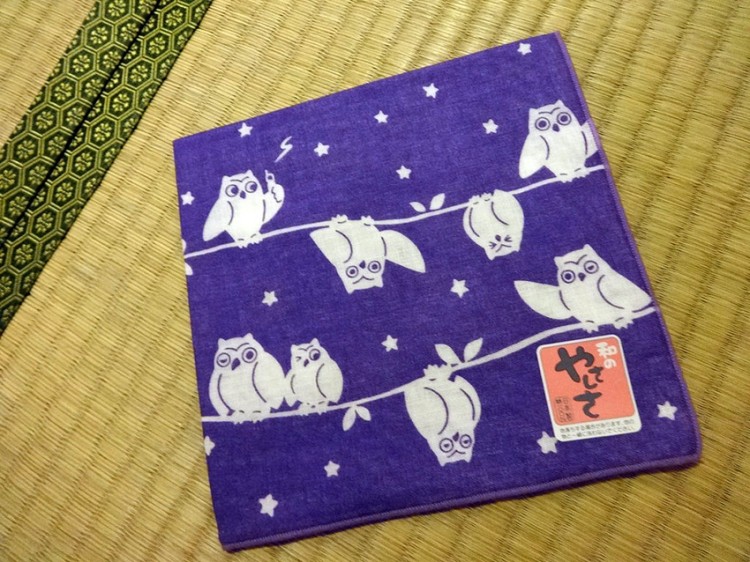 cloth featuring white cartoon fukuro on purple background