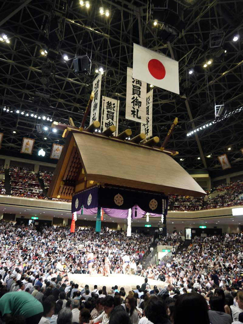 hanging banners and Japanese flag over sumo arena