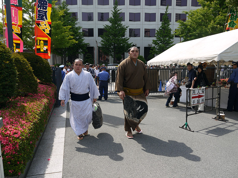 pair of sumo wrestlers heading to stadium