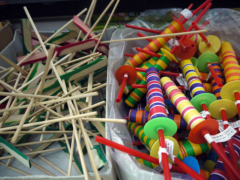 wooden flying toy and paper yoyos