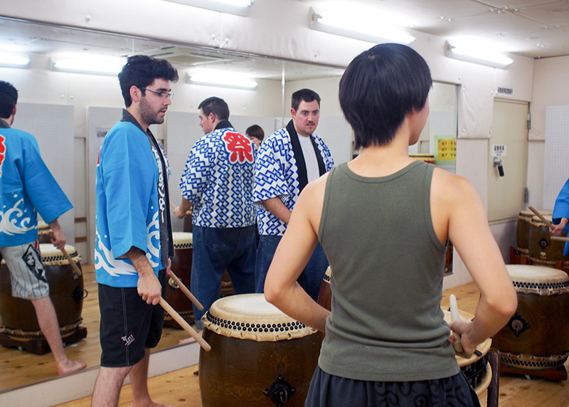 foreigners in a circle learning taiko in japan