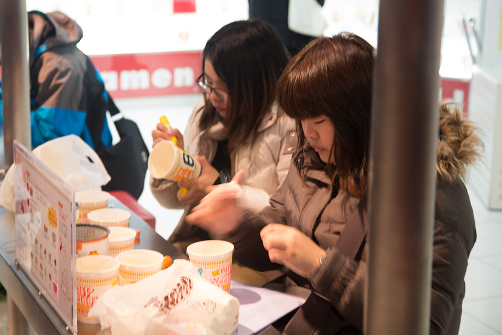 women putting together their own noodle cups