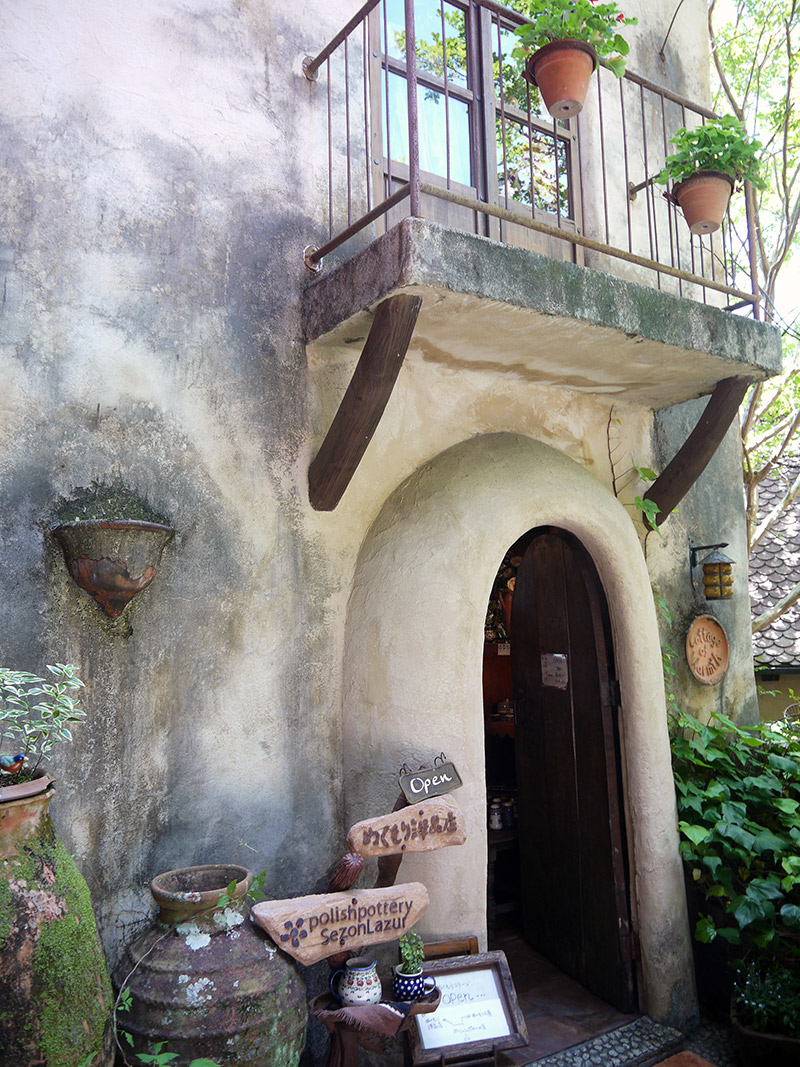 simple doorway with overhanging balcony at ghibli village in japan