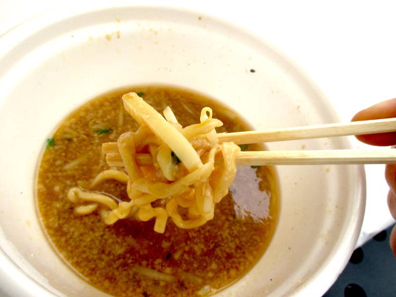 end of a bowl of miso ramen plastic bowl pork