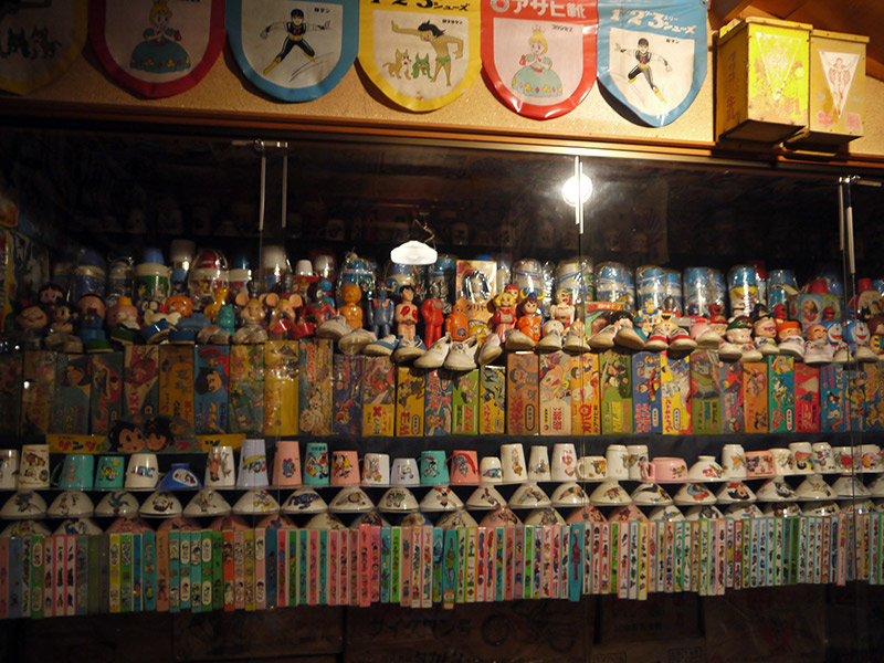 A variety of vintage toy boxes on a shelf